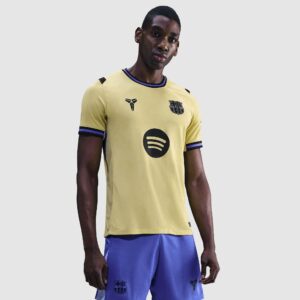 https://www.prodirectsport.com/soccer/p/nike-fc-barcelona-25-26-dri-fit-stadium-ss-away-shirt-team-gold-team-gold-persian-violet-black-mens-replica-1035987